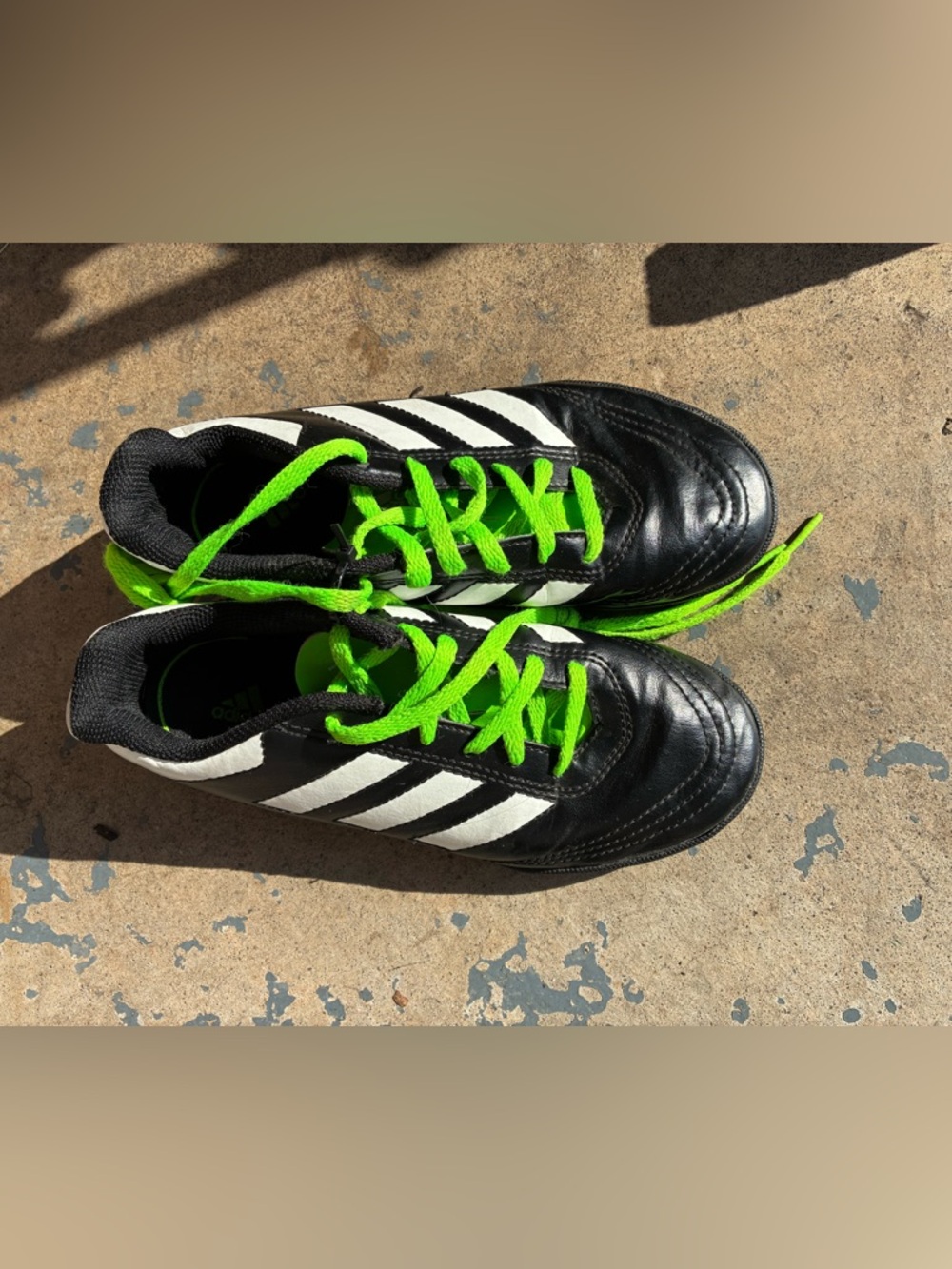 adidas Kids Black Soccer shoes with White Stripes and Neon Green Laces